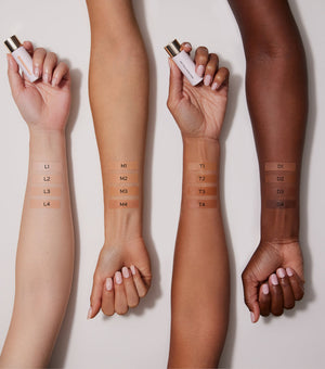 Multiple skin tones with makeup swatches on wrists against a neutral background