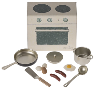 Miniature kitchen set with stove and utensils on a white background