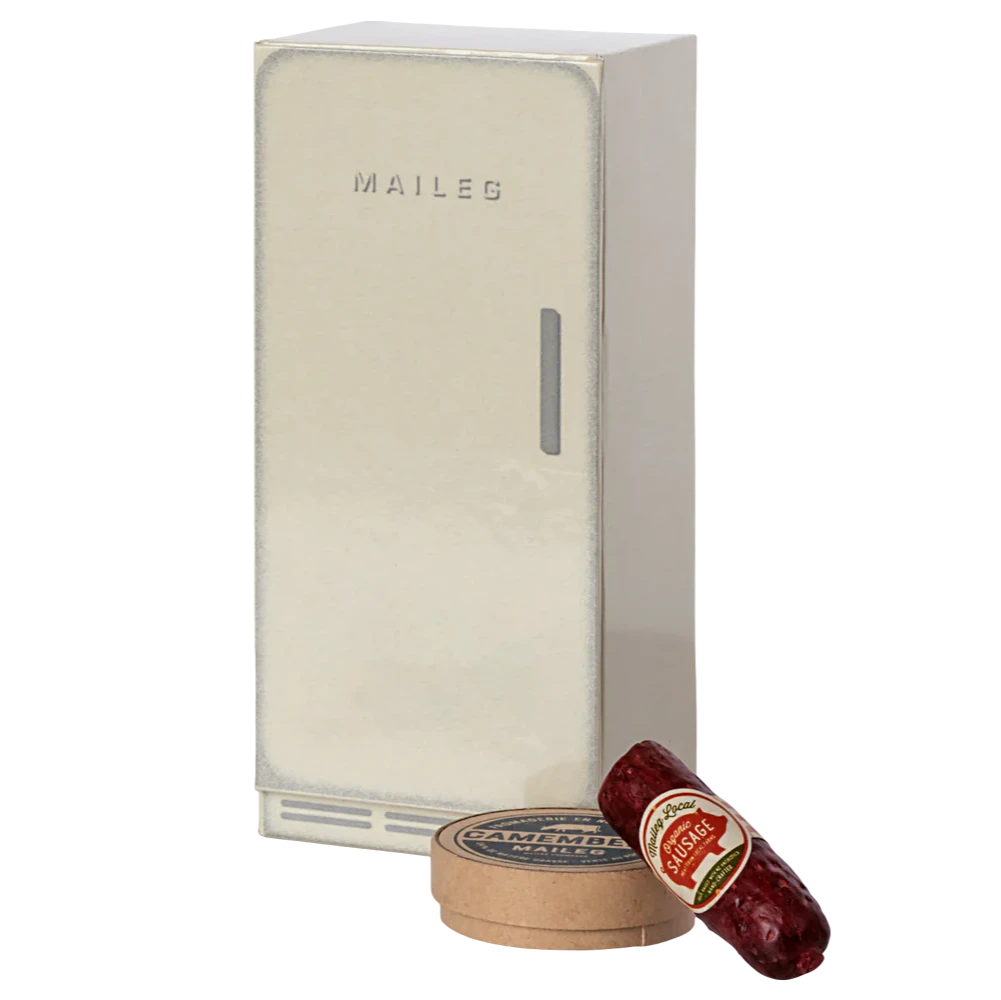 A beige Maileg mouse cooler with a small sausage and cheese pack in front of it, designed to look like a mouse castle.
