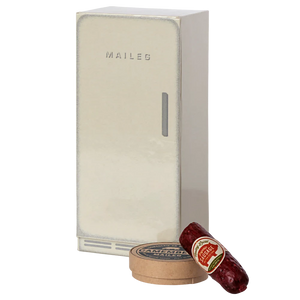 A beige Maileg mouse cooler with a small sausage and cheese pack in front of it, designed to look like a mouse castle.