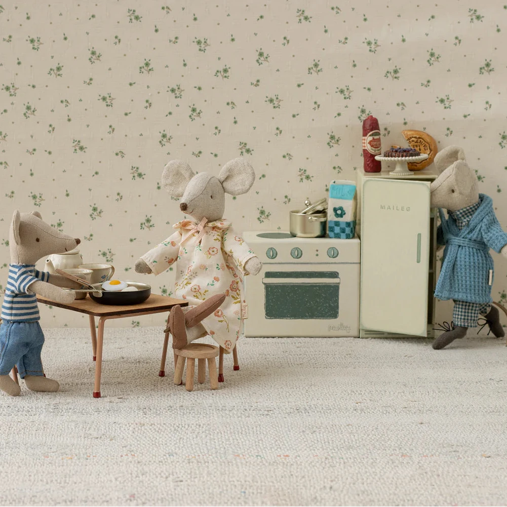 Miniature mouse family scene with a refrigerator, stove, and table.