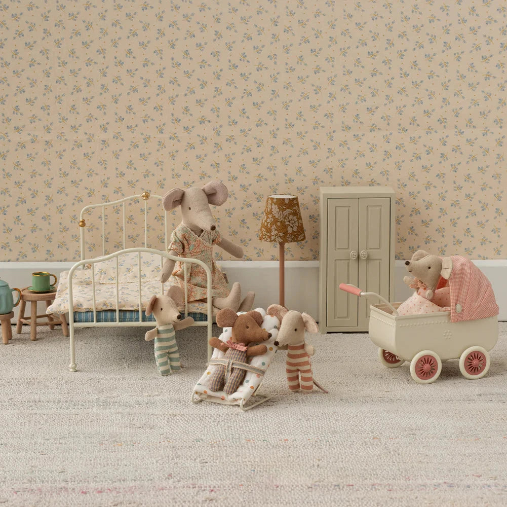 A toy pram in coral and beige colors with a checkered canopy and four wheels, designed for small toy mice.