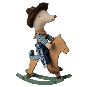 Toy mouse in cowboy outfit riding a wooden rocking horse on a white background