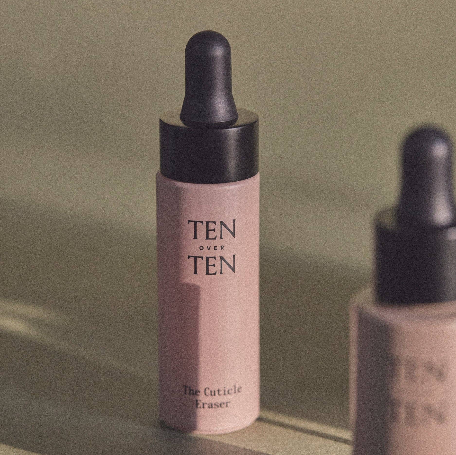 Two 'TEN OVER TEN' skincare bottles on a neutral background