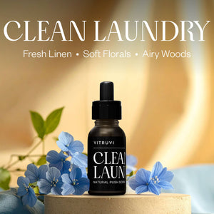Vitruvi Clean Laundry product with flowers and text on a blurred background