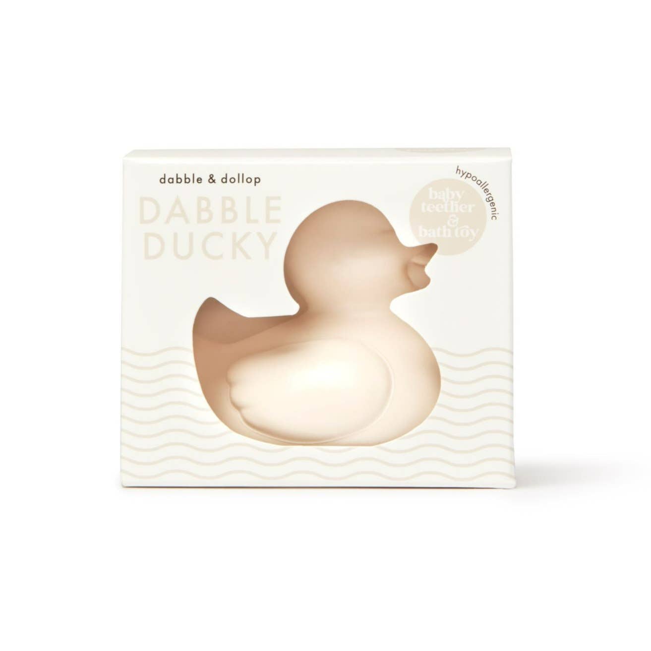 A beige rubber ducky bath toy in its packaging, labeled 'Dabble & Dollop' and noted as latex-free.