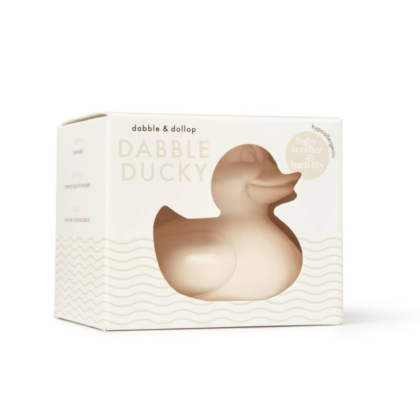 A beige rubber ducky bath toy in its packaging, labeled 'Dabble & Dollop' and noted as latex-free.