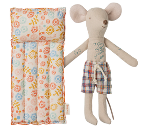 A toy mouse in beige color with a floral patterned air mattress.