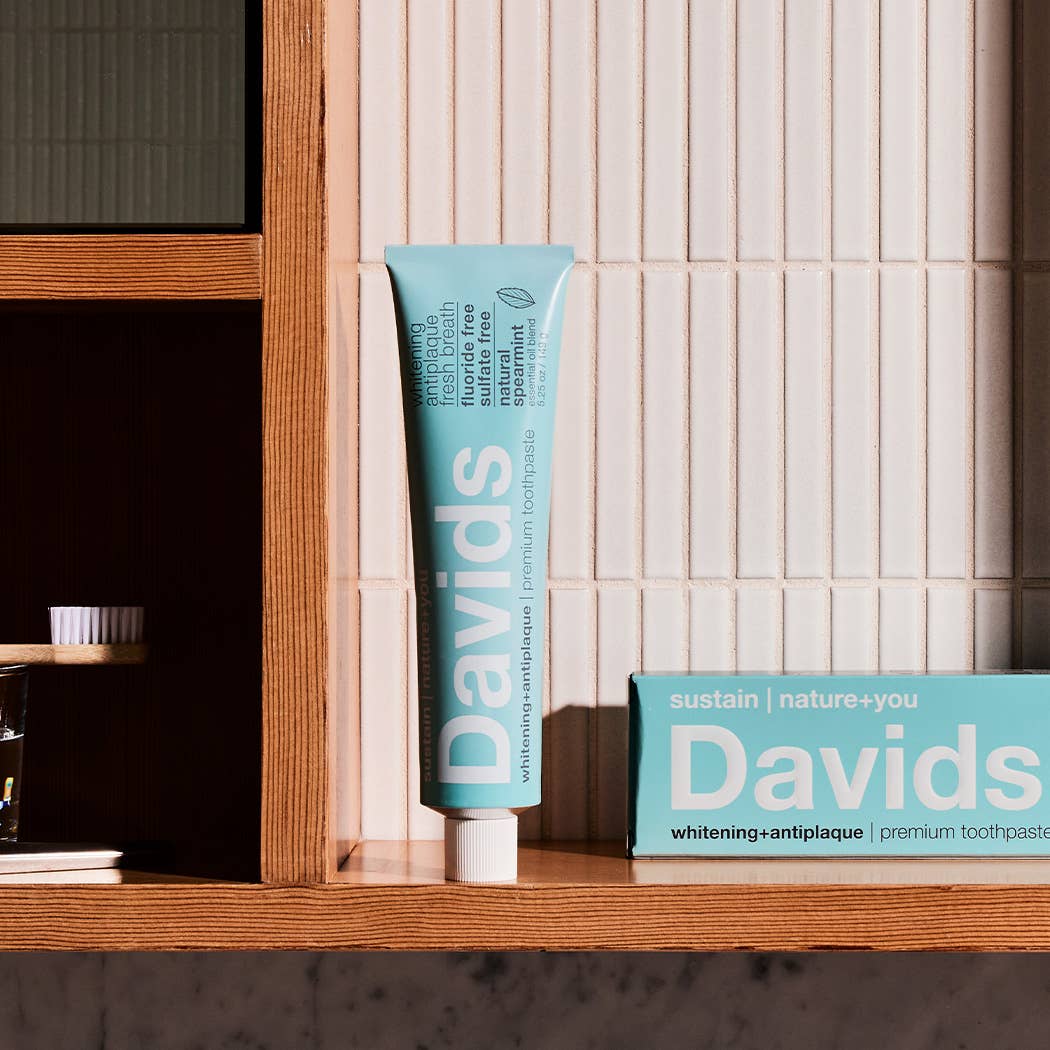 A tube of Davids toothpaste in a bathroom environment. 