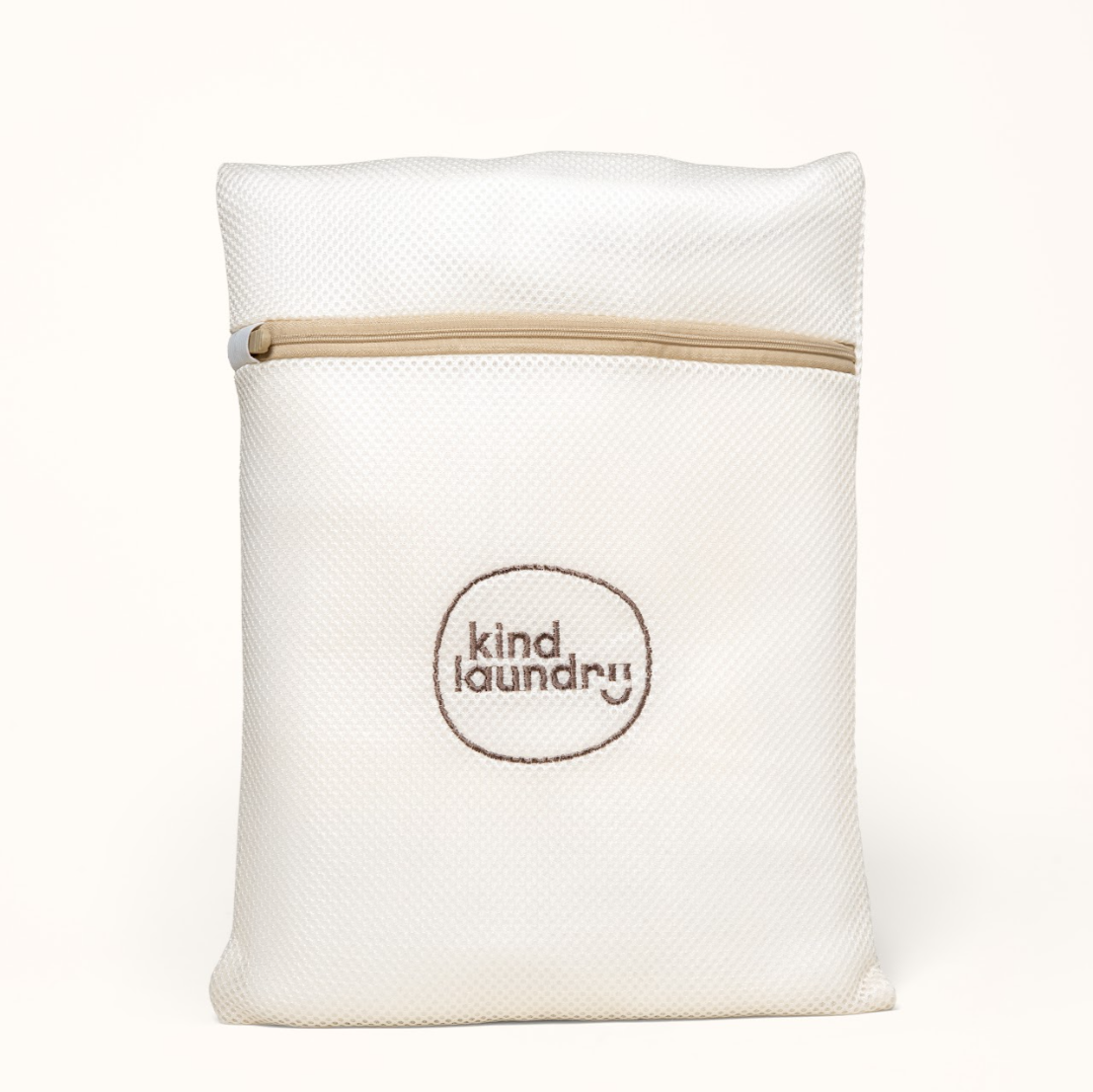 A white premium washable mesh laundry bag with a zipper handle, featuring the 'Kind Laundry' brand logo on the front.