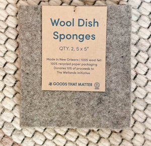 A wool dish sponge with a brown paper tag. 