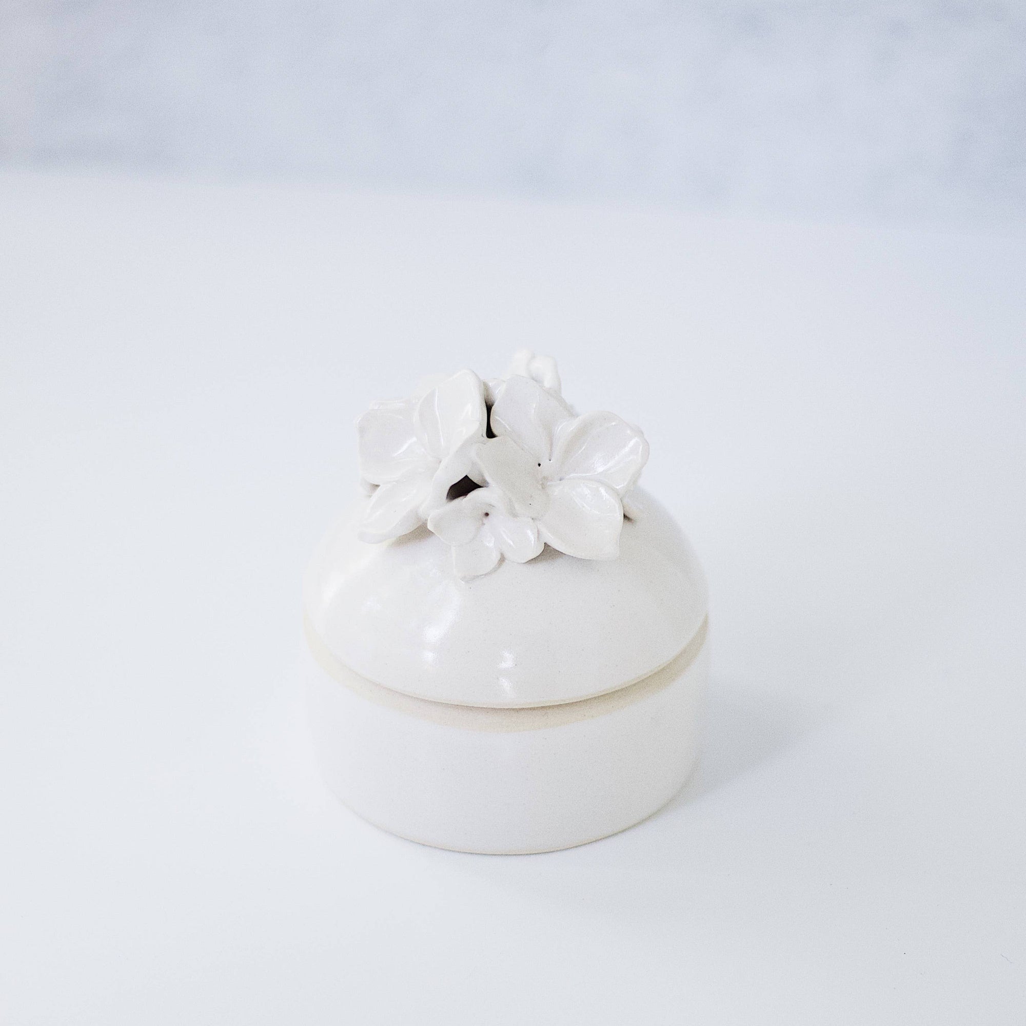 A white trinket jar. 