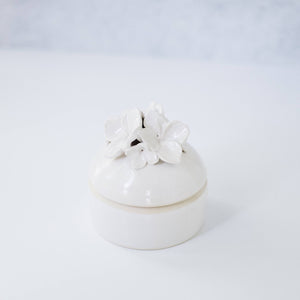 A white trinket jar. 