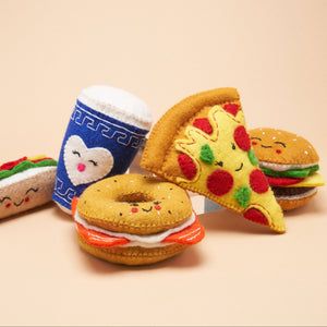 A group of felt dog toys, shaped like a bagel, a cup of coffee, a hamburger, and a slice of pizza