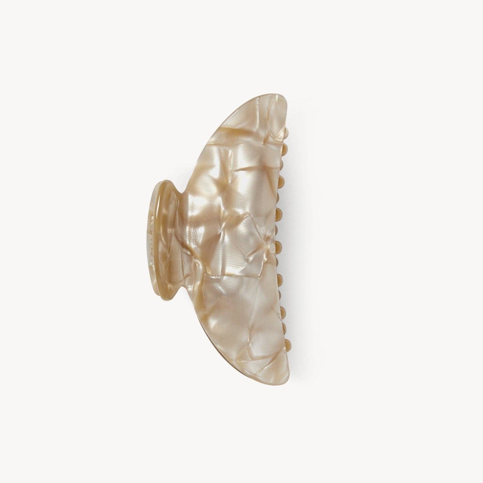 Shell-shaped hair clip on a white background