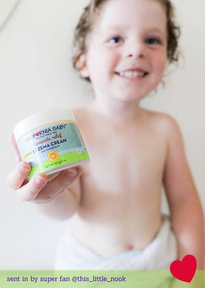 Child holding a jar of Zema Cream with a heart and text overlay