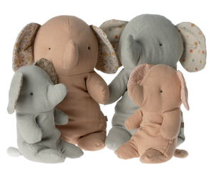 Set of four plush elephant toys in different colors on a white background
