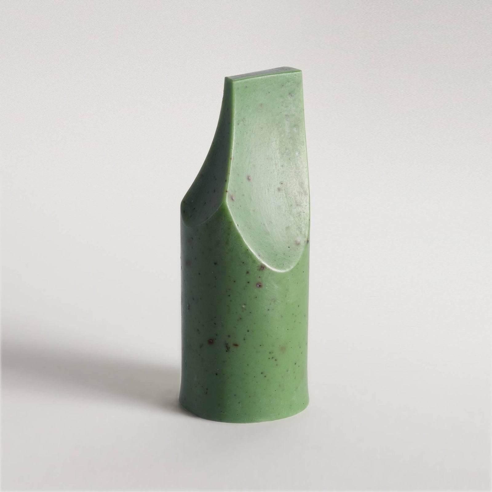 A UMÉ Erode Soap Mini bar next to its packaging box, with a reflective surface in the background.