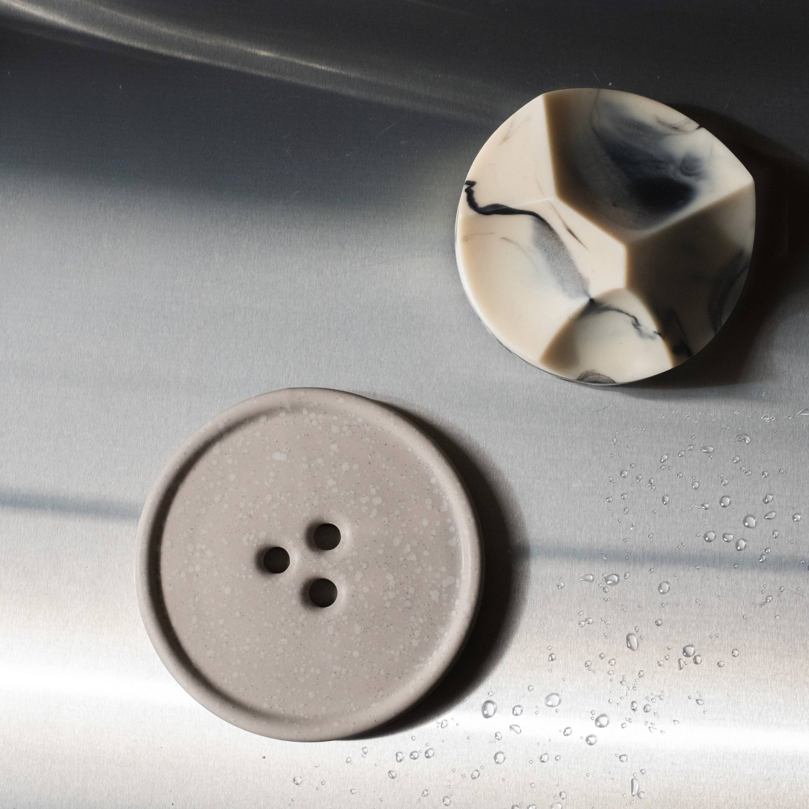 A gray bouton on a white surface. 