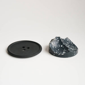 An ume studios erode soap and a black bouton. 
