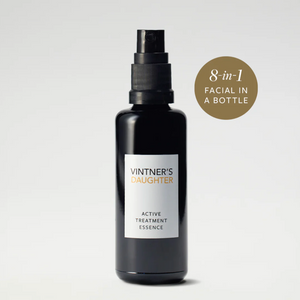 A black spray bottle labeled 'Vintner's Daughter Active Treatment Essence' with a badge stating '8-in-1 Facial in a Bottle'.