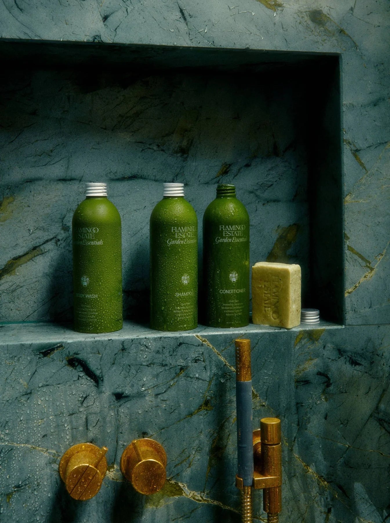 Flamingo Estate Garden Essentials Clary Sage body wash, on a ledge in a shower