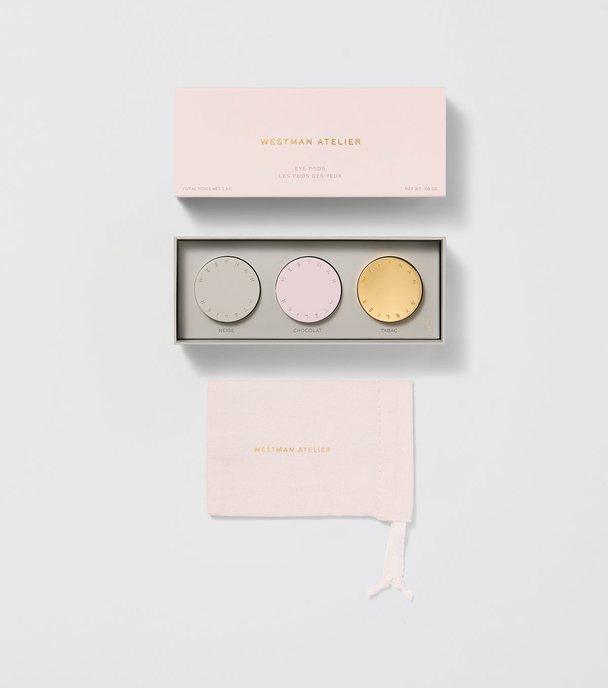 Three round eye shadow pods with a cream-to-powder consistency, displayed in natural shades with a golden, pink, and purple color scheme. Each pod has a unique texture with a logo at the center.