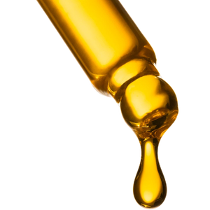 Close-up of a dropper with yellow liquid on a white background