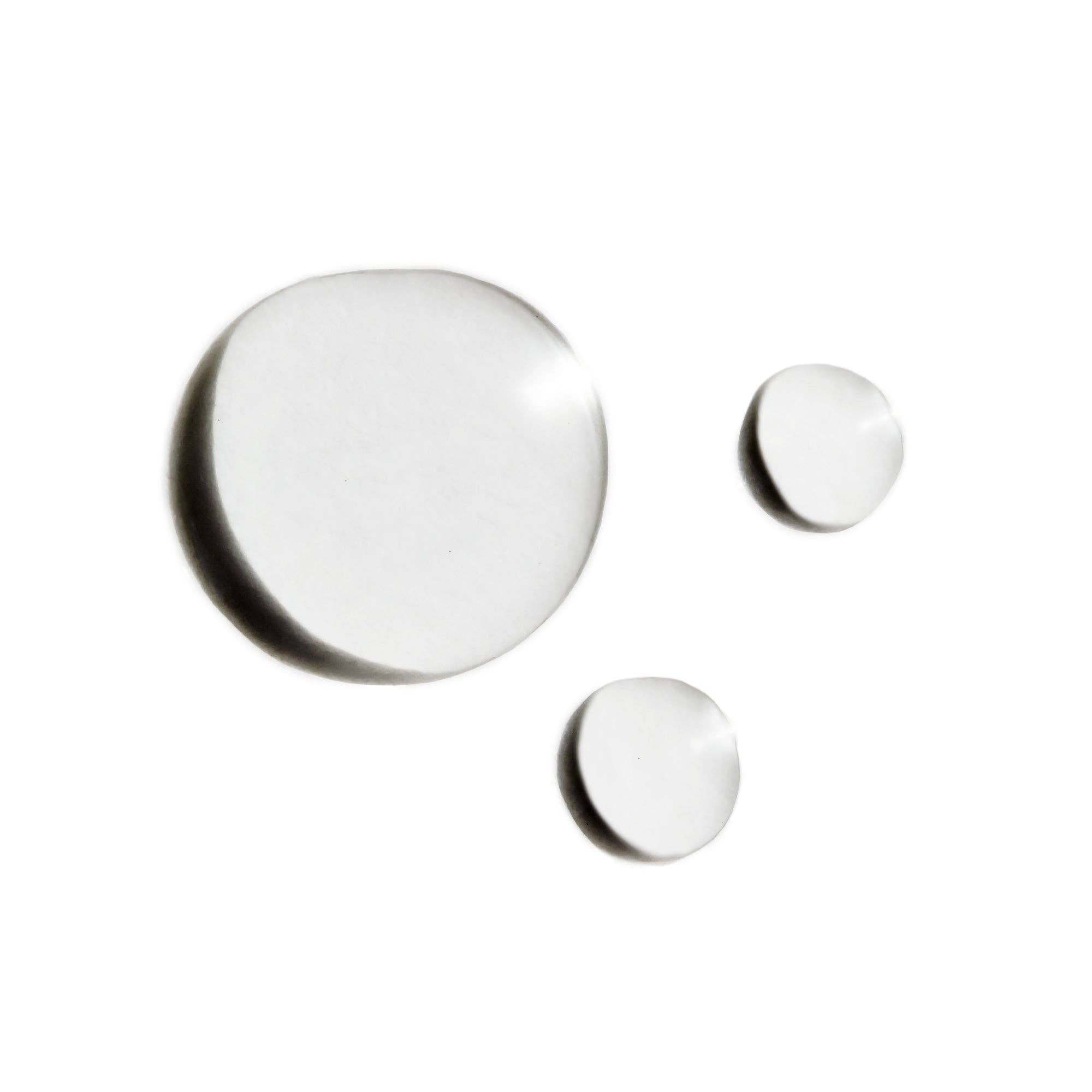 A bottle of Indie Lee Squalane Facial Oil with a white label and cap, contained in a clear glass bottle with a dropper.