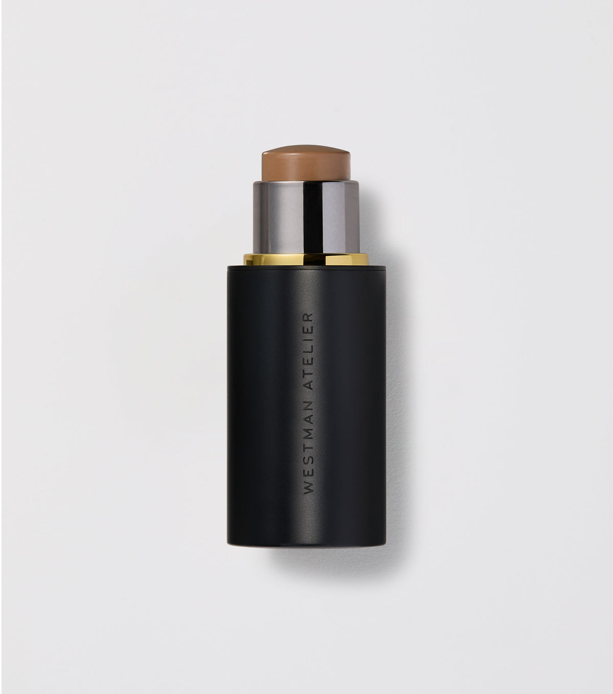 A contour stick by Westman Atelier with a visible creamy product and a black twist-up tube.