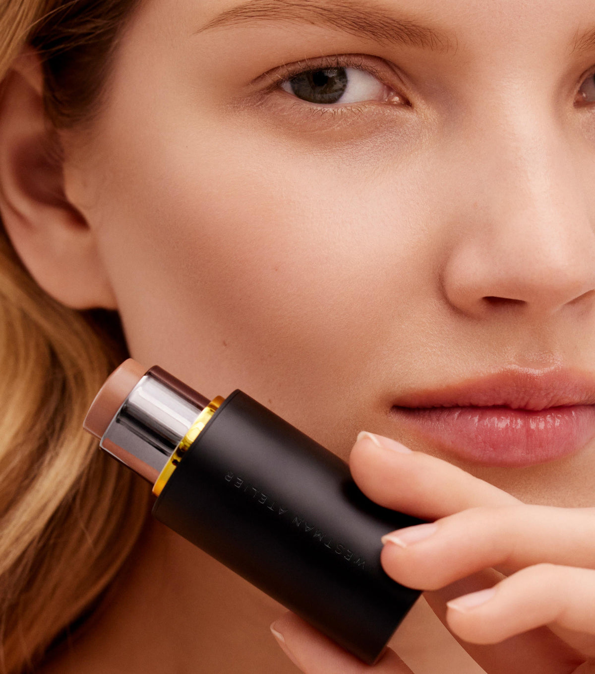 A contour stick by Westman Atelier with a visible creamy product and a black twist-up tube.