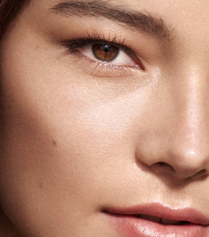 Close-up of a person's eye with a soft focus on the skin texture.