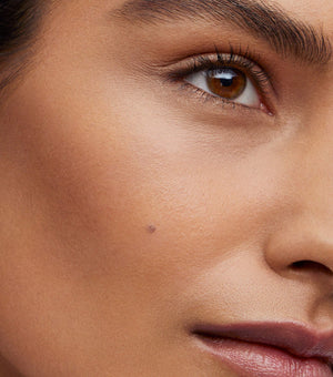 Close-up of a person's eye with a focus on skin texture and color.