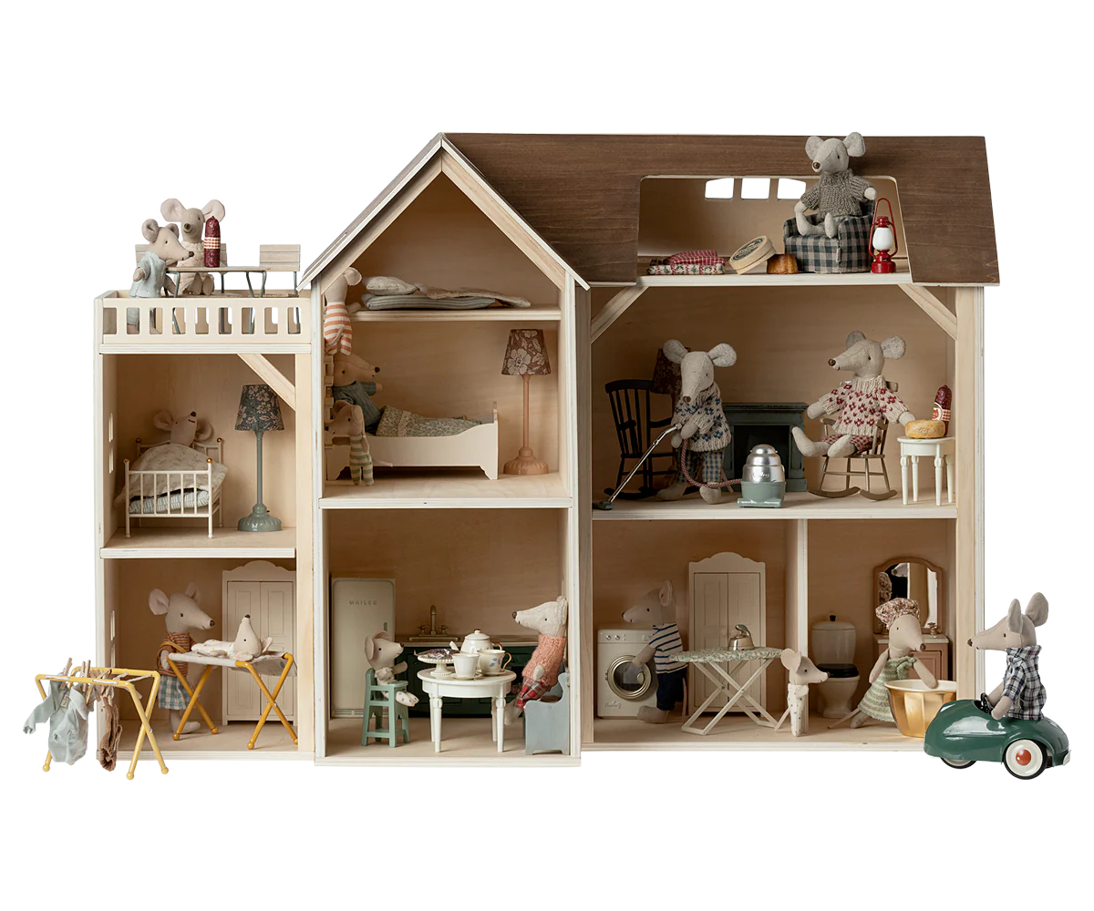 Wooden dollhouse with miniature furniture and toy mice