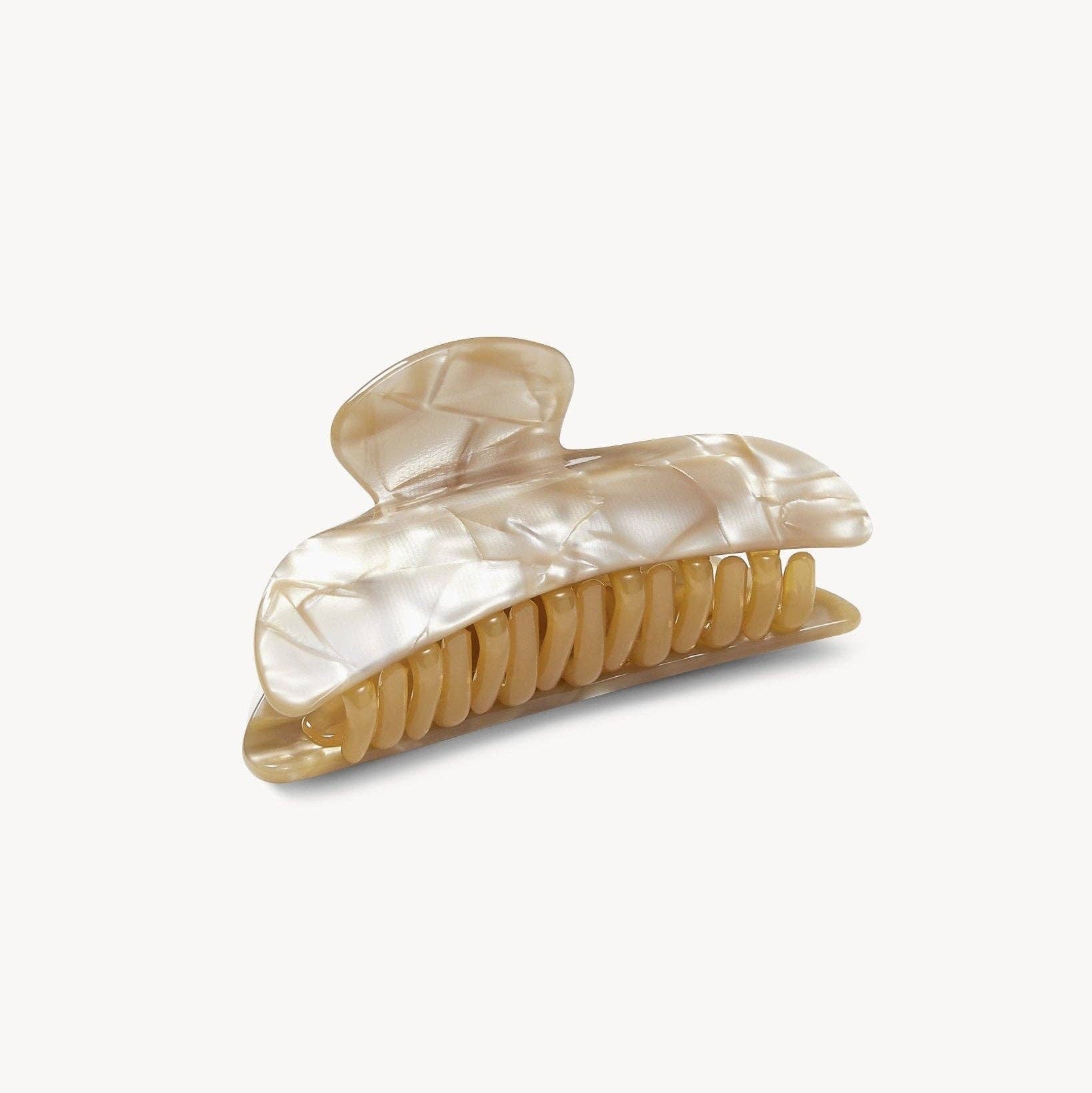 Beige hair clip with a clear shell-like design on a white background