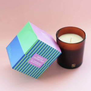 Candle with a geometric box on a pink background