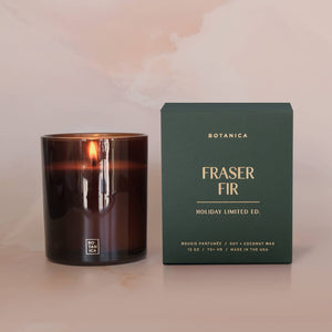 Candle and its packaging labeled 'Fraser Fir' on a neutral background