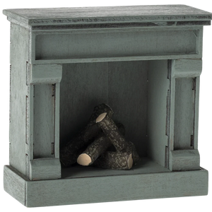 A small, toy-scale wooden fireplace with a vintage finish in blue color, featuring a log inside.
