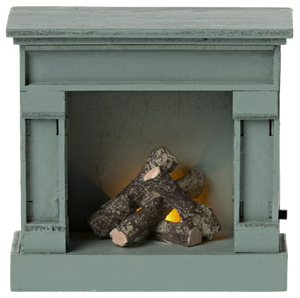 Small green fireplace with logs inside on a white background