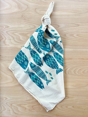 The Noon Designs fish tea towel is white with blue fish printed on it. 