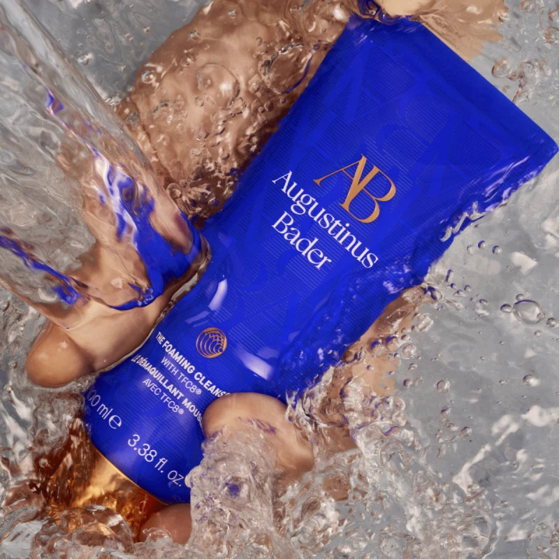 A bottle of the foaming cleanser running under water