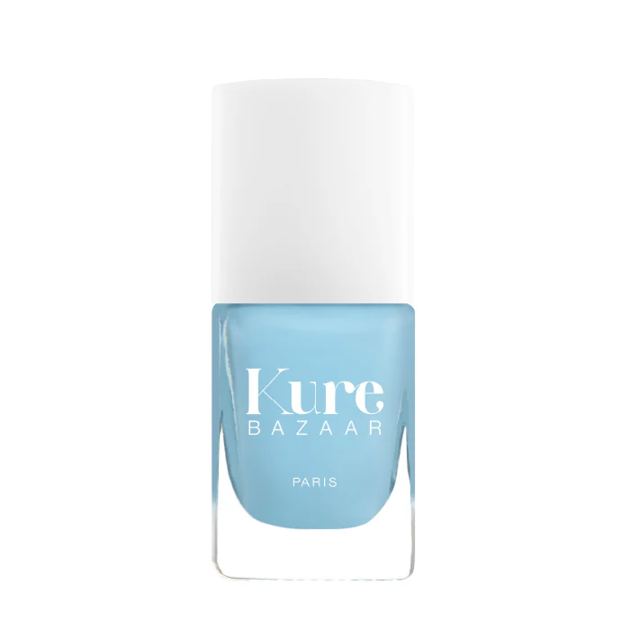 A bottle of Kure Bazaar nail polish in a pastel blue shade with the brand name and 'Paris' printed on the label.