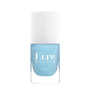 A bottle of Kure Bazaar nail polish in a pastel blue shade with the brand name and 'Paris' printed on the label.