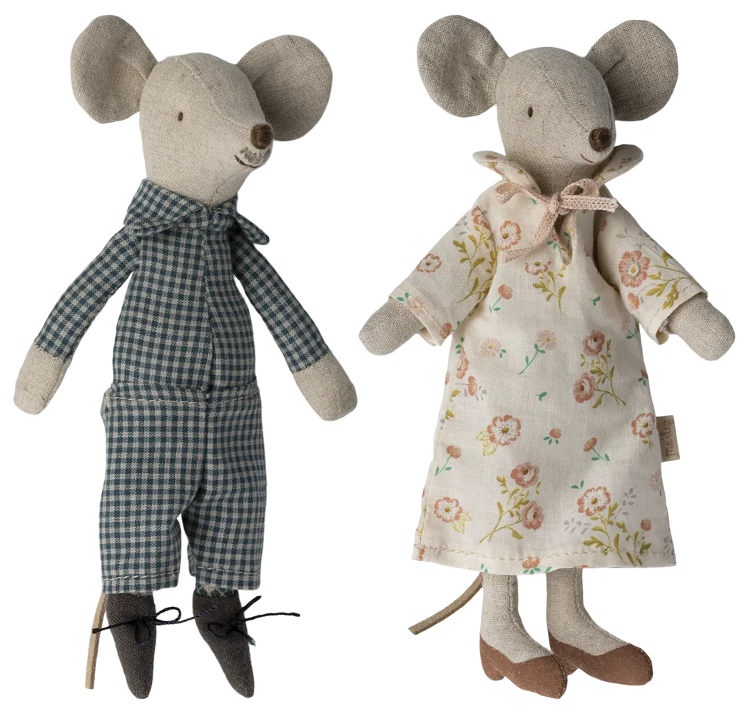 Two toy mice, one in a checkered outfit and the other in a floral dress, on a white background.