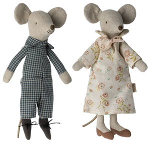 Two toy mice, one in a checkered outfit and the other in a floral dress, on a white background.