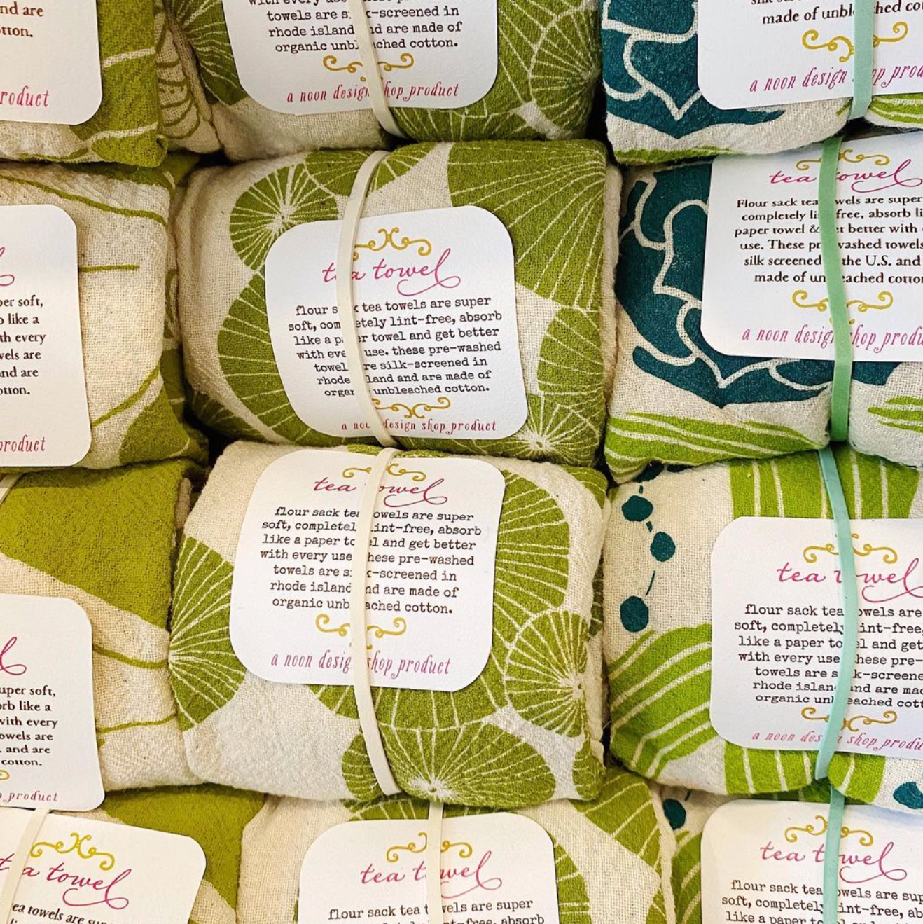 A batch of green and white tea towels
