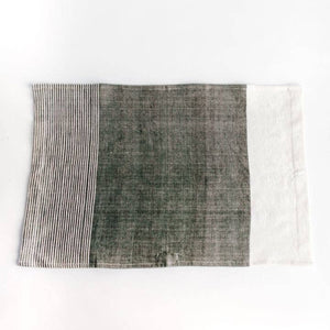 A color block tea towel in grey and white. 