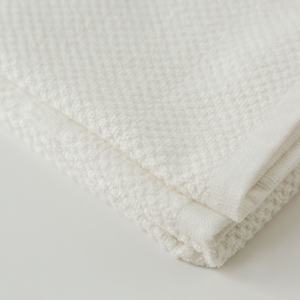 White textured towel on a light gray background