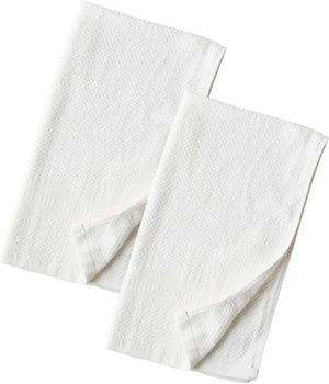 Two white folded towels on a white background