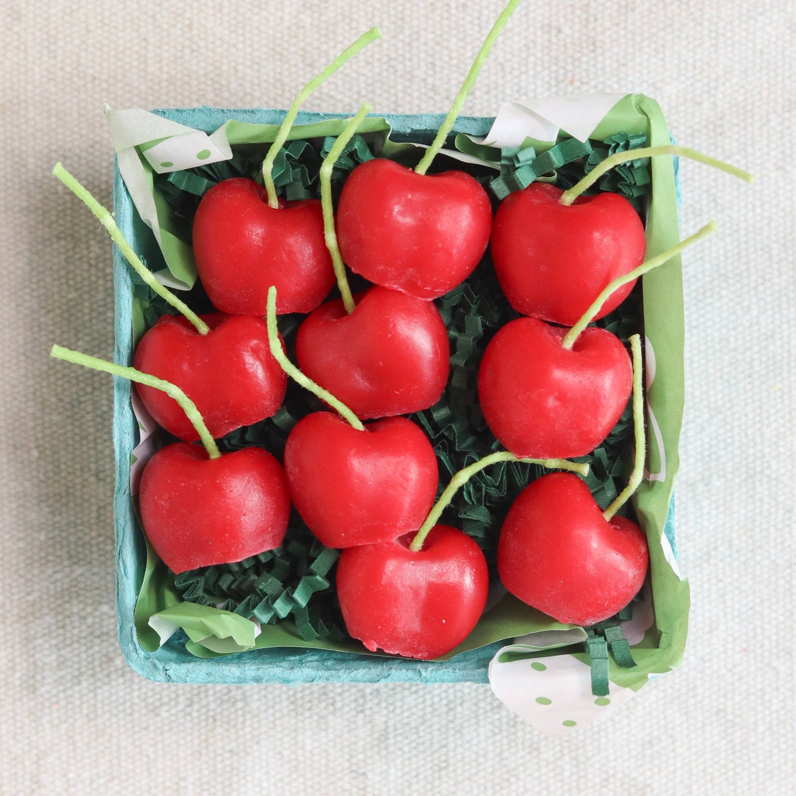 A box of organic cherry candles, made in California by Happy Organics